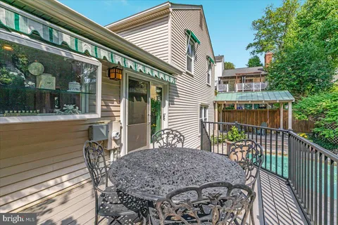 a backyard of a house with table and chairs