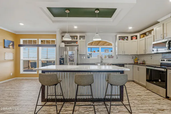 a bedroom with three beds and a window