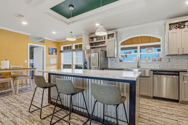 a bathroom with a granite countertop sink a mirror and a shower