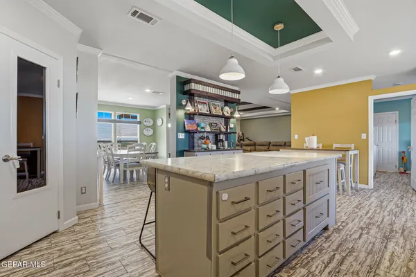 a living room with furniture a flat screen tv and a bookshelf