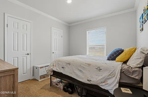 a bedroom with a bed and flat screen tv