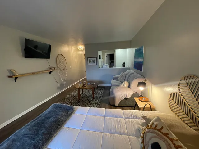 a view of a livingroom with furniture and a flat screen tv