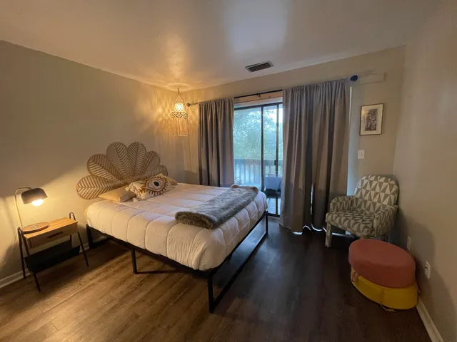 a bedroom with a bed and wooden floor