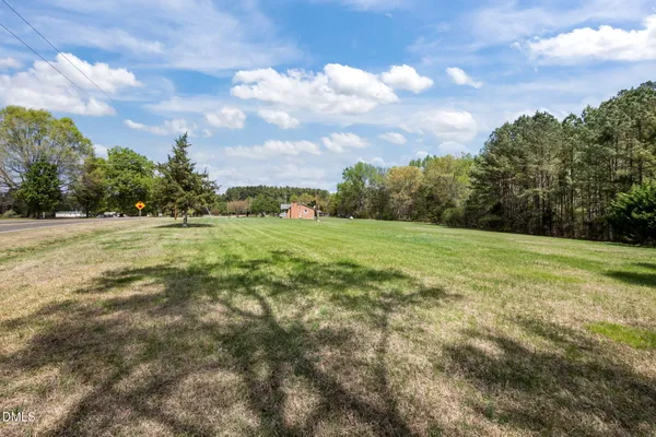 a view of outdoor space with deck area and trees all around