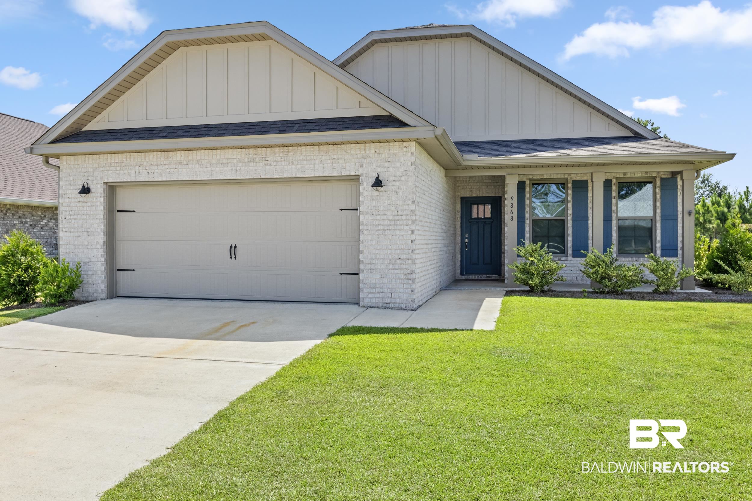 Craftsman house with a garage and a front lawn