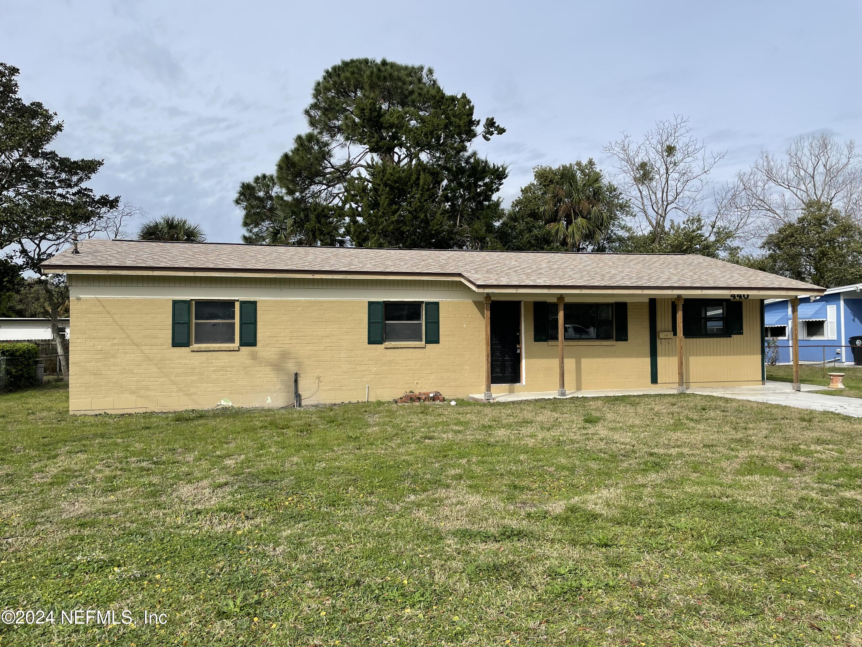 440 Sargo Road Atlantic Beach, FL 32233 - Photo 1 of 15 a front view of a house with a garden