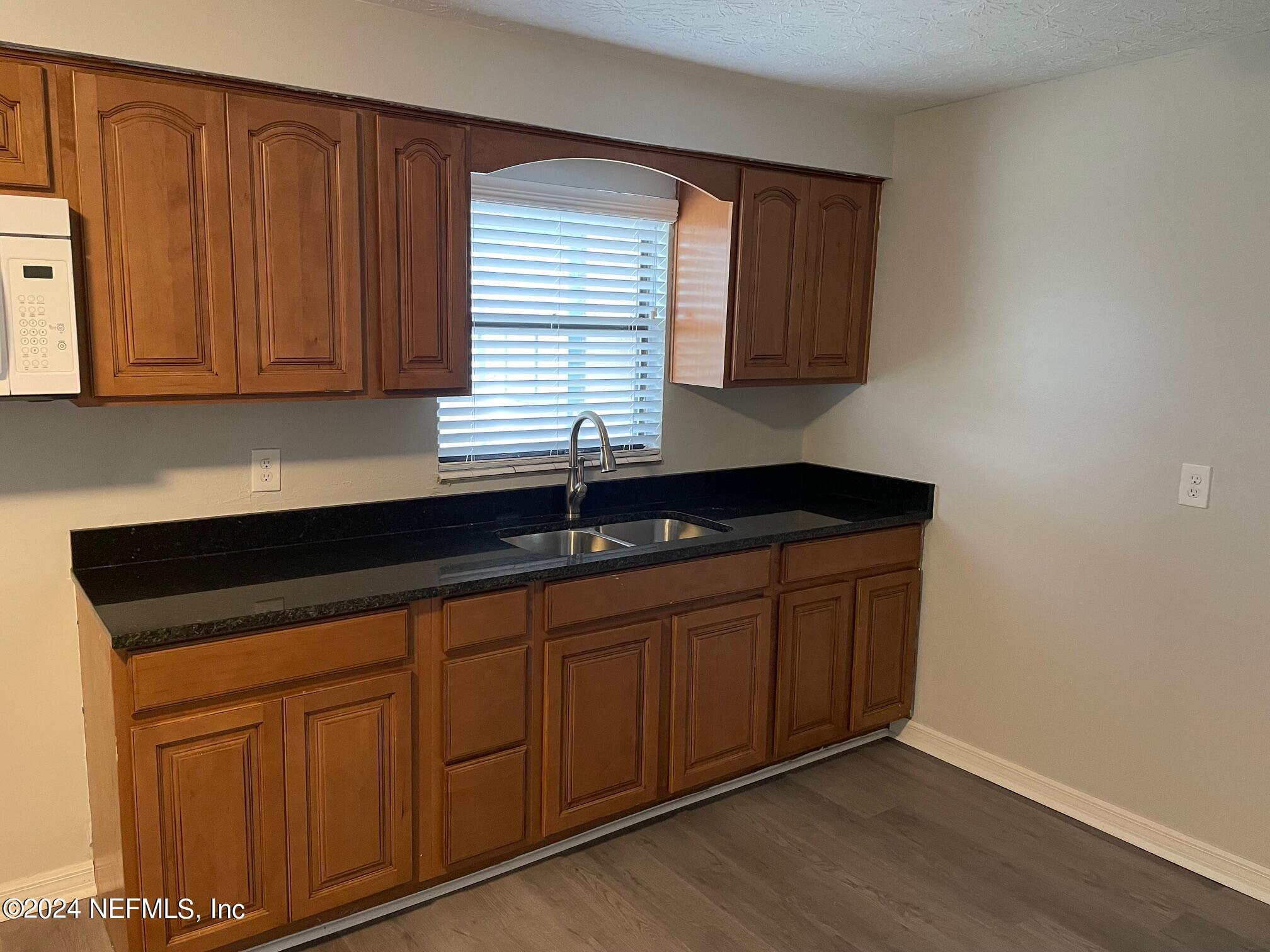 440 Sargo Road Atlantic Beach, FL 32233 - Photo 3 of 15 a kitchen with granite countertop cabinets sink and dishwasher