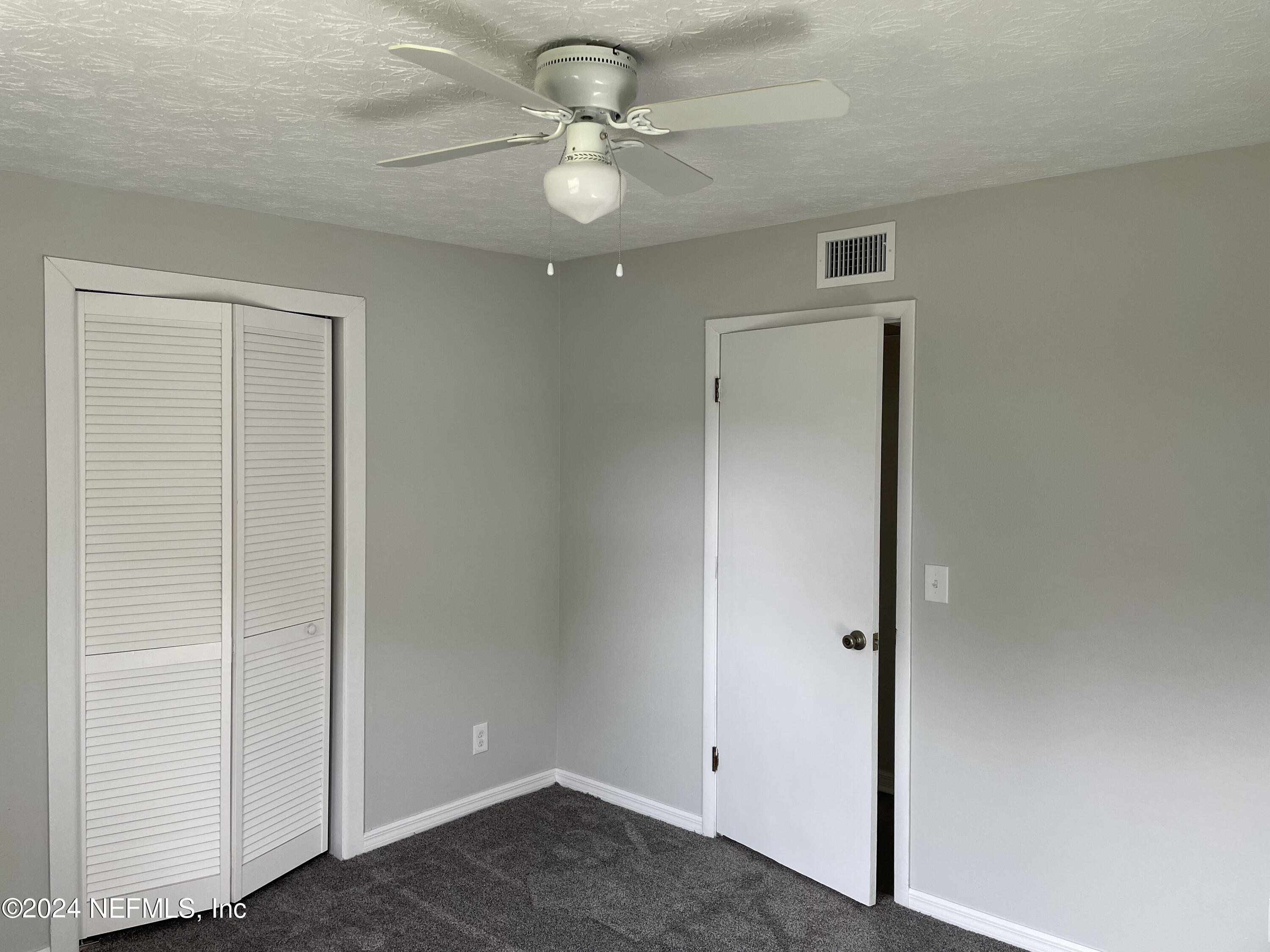 440 Sargo Road Atlantic Beach, FL 32233 - Photo 9 of 15 an empty room with closet and ceiling fan