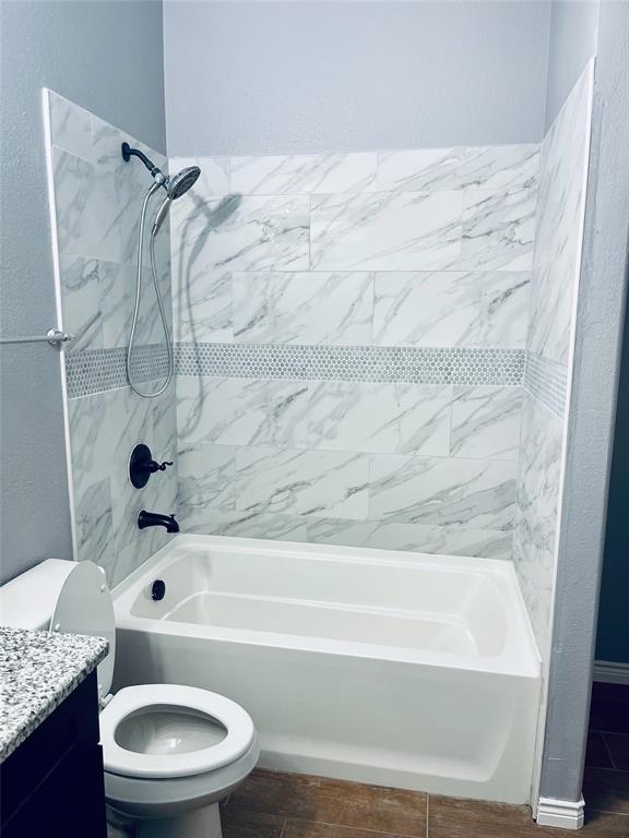 548 Kerry Street Crowley, TX 76036 - Photo 22 of 35 a bathroom with a granite countertop bathtub shower sink vanity and toilet
