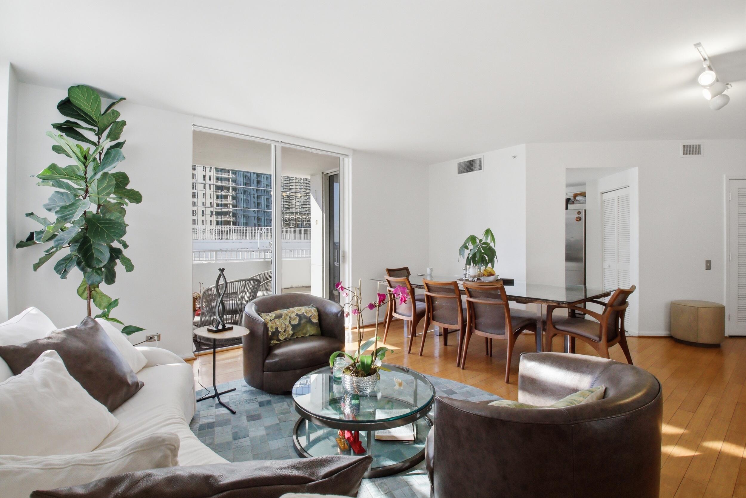 701 Brickell Key Boulevard, Unit 610 Miami, FL 33131 - Photo 11 of 40 a living room with furniture potted plant and a window