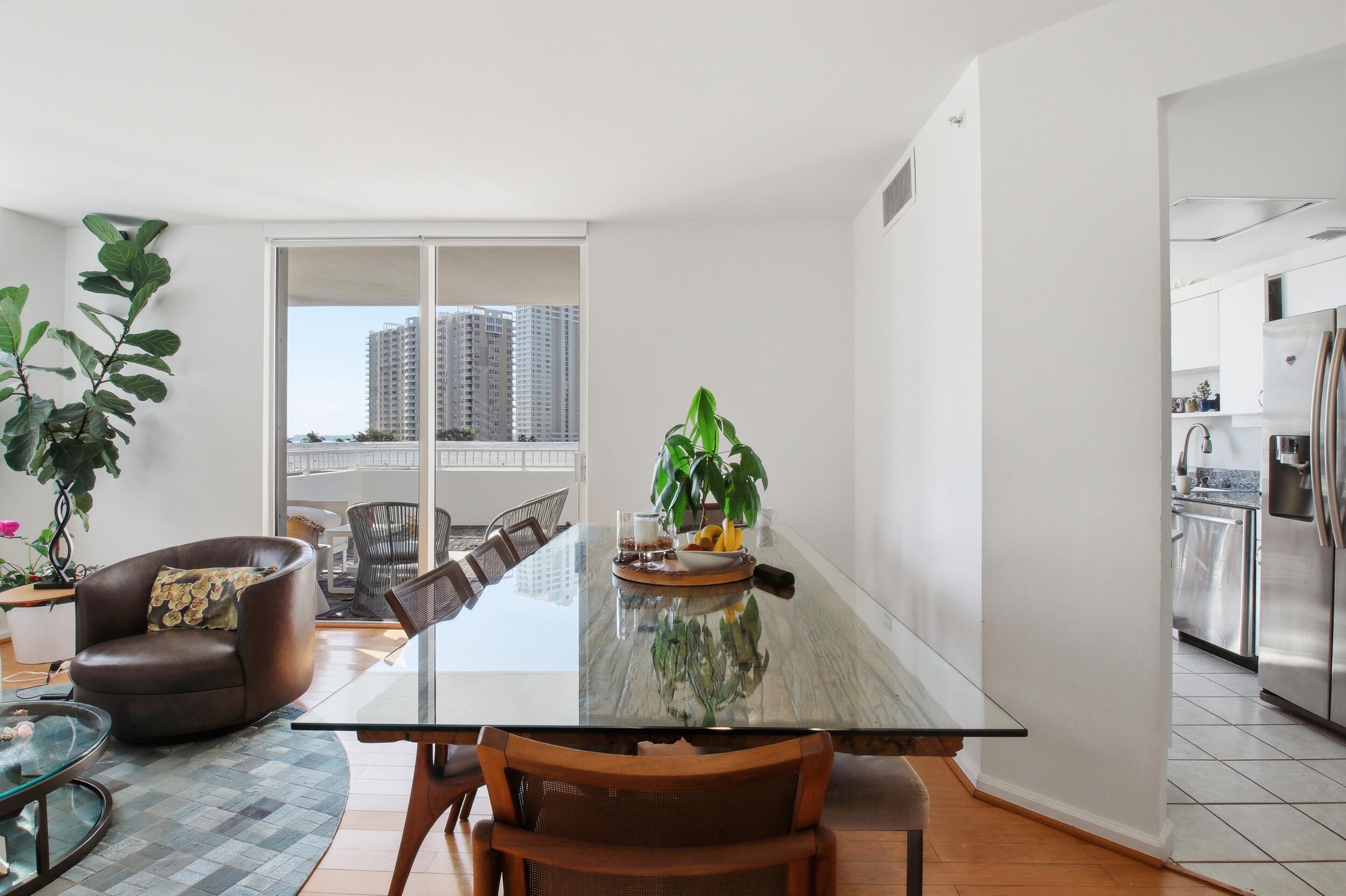 701 Brickell Key Boulevard, Unit 610 Miami, FL 33131 - Photo 13 of 40 a view of a dining room with furniture and wooden floor