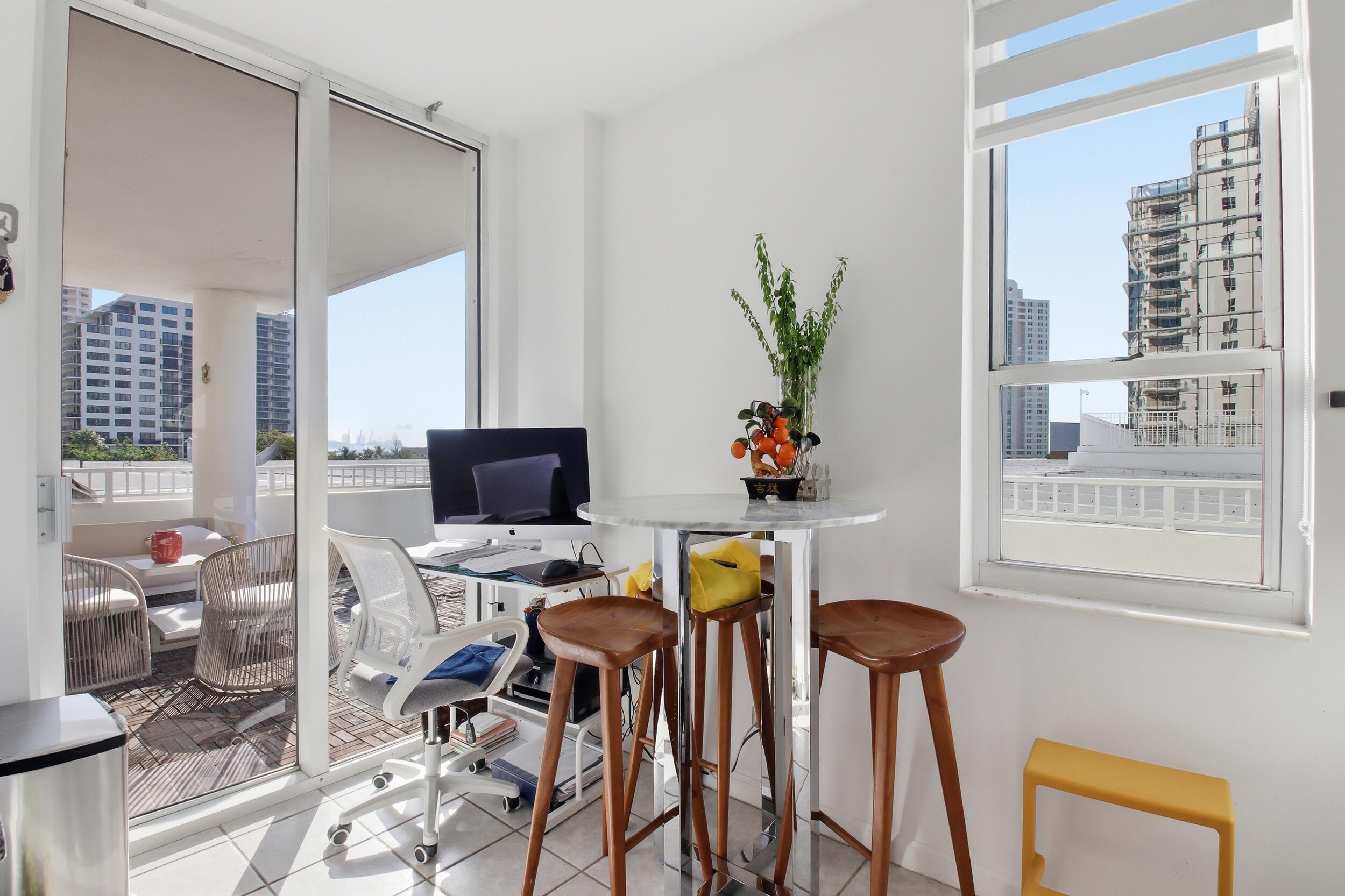 701 Brickell Key Boulevard, Unit 610 Miami, FL 33131 - Photo 15 of 40 a view of a workspace with furniture and a potted plant