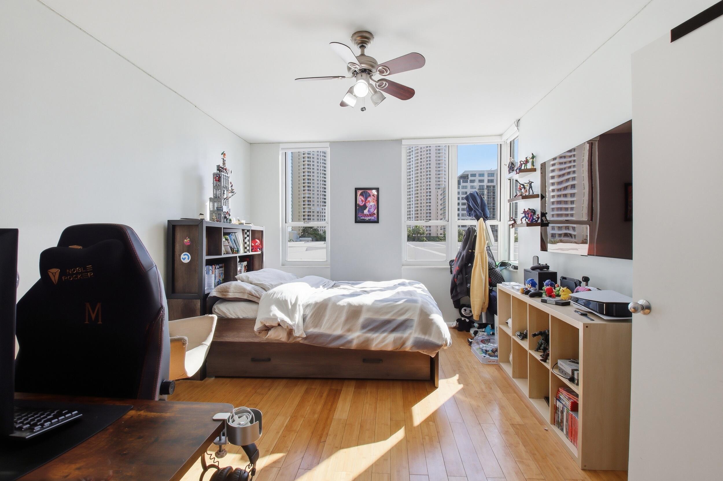 701 Brickell Key Boulevard, Unit 610 Miami, FL 33131 - Photo 17 of 40 a bedroom with furniture and a flat screen tv