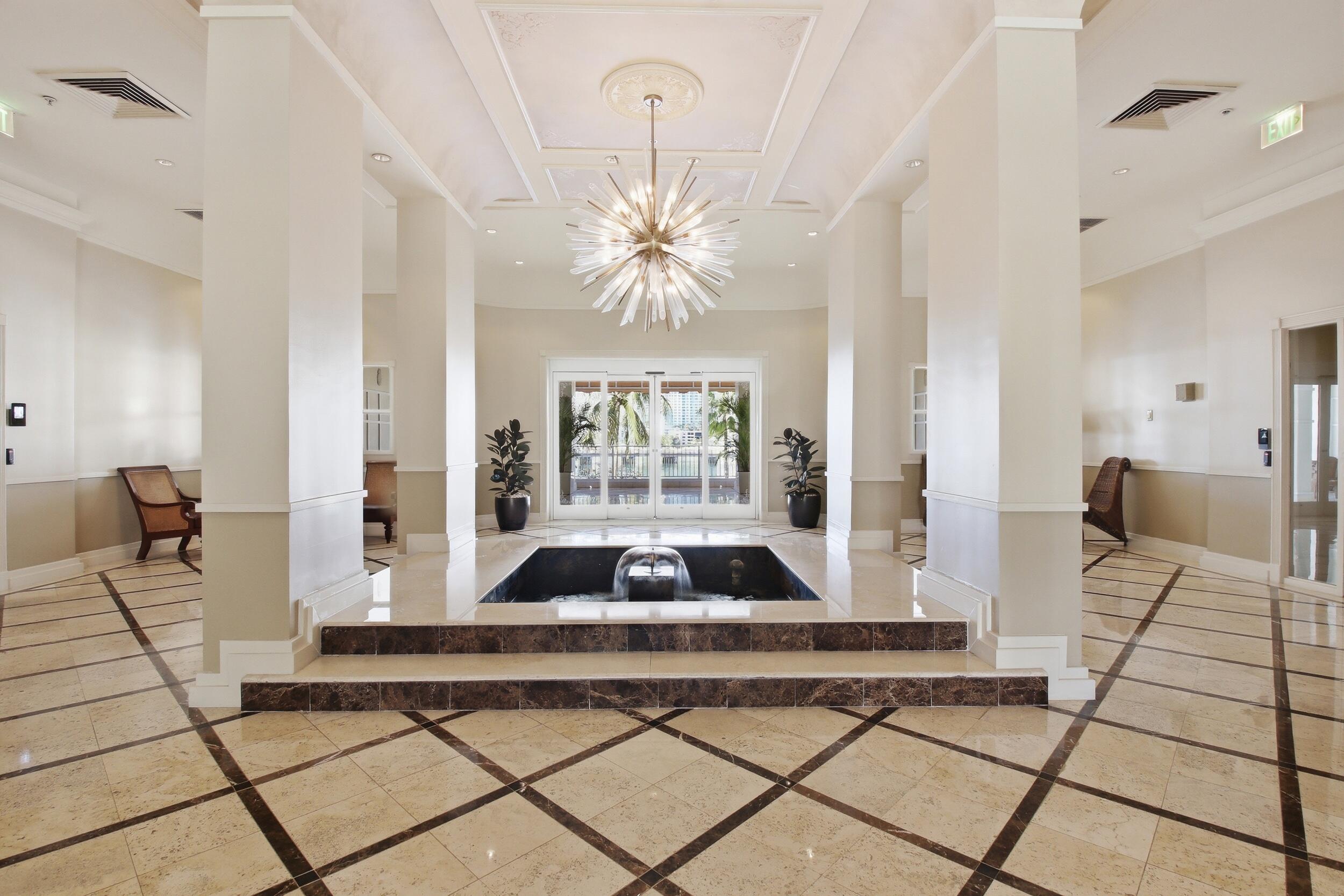 701 Brickell Key Boulevard, Unit 610 Miami, FL 33131 - Photo 25 of 40 a living room with a floor to ceiling window and a rug