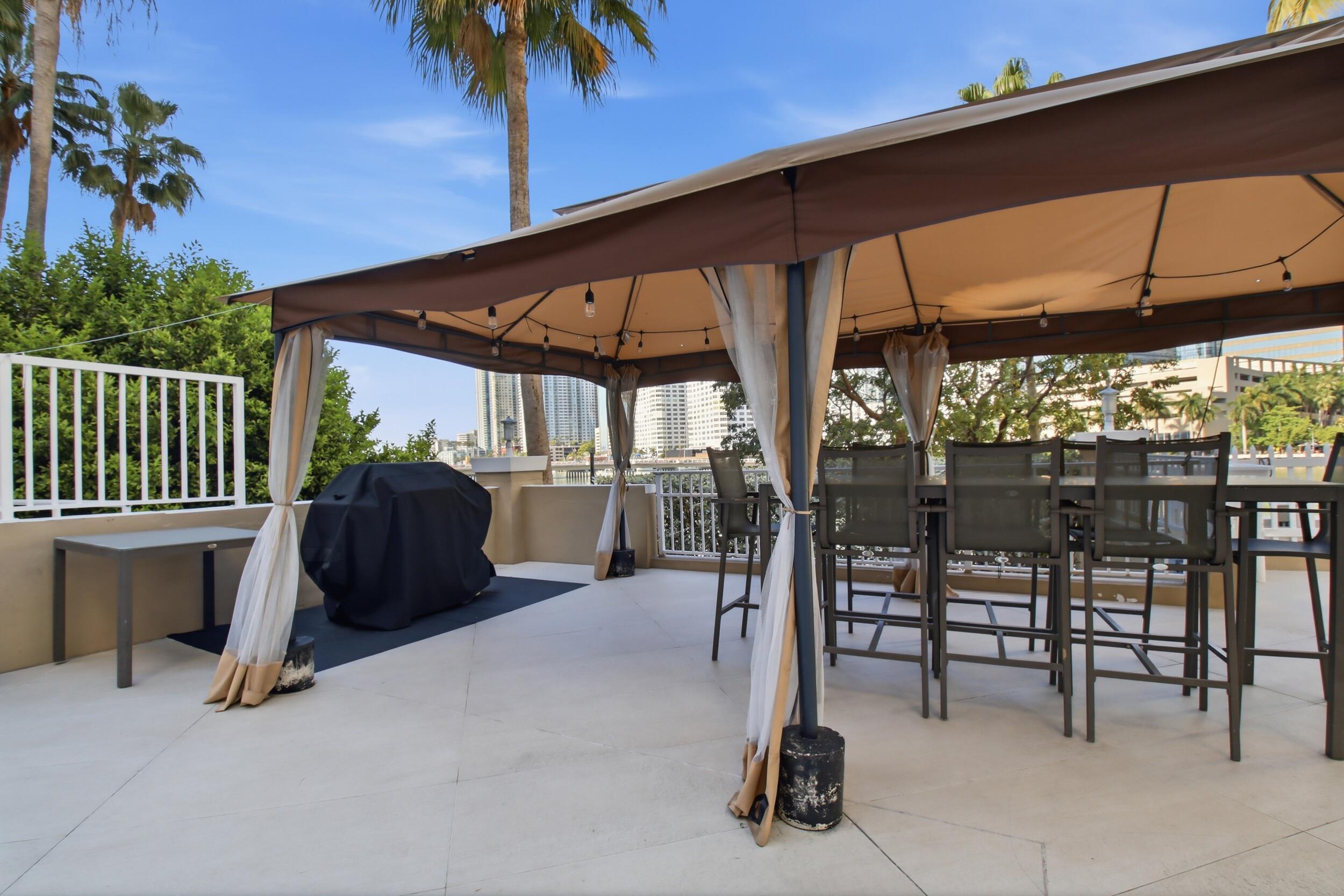 701 Brickell Key Boulevard, Unit 610 Miami, FL 33131 - Photo 26 of 40 a view of a porch with furniture and a yard