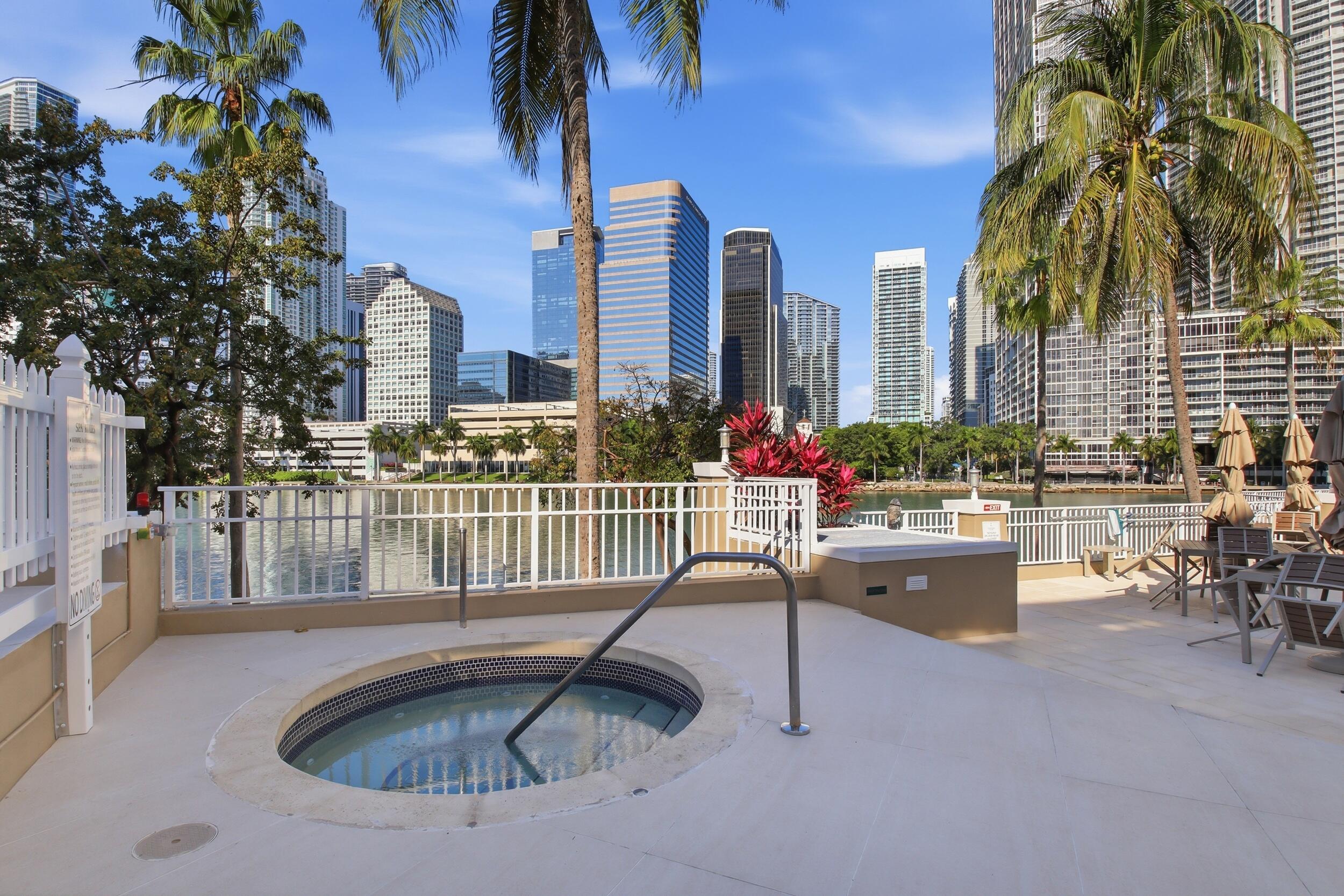 701 Brickell Key Boulevard, Unit 610 Miami, FL 33131 - Photo 27 of 40 a swimming pool with outdoor seating and yard