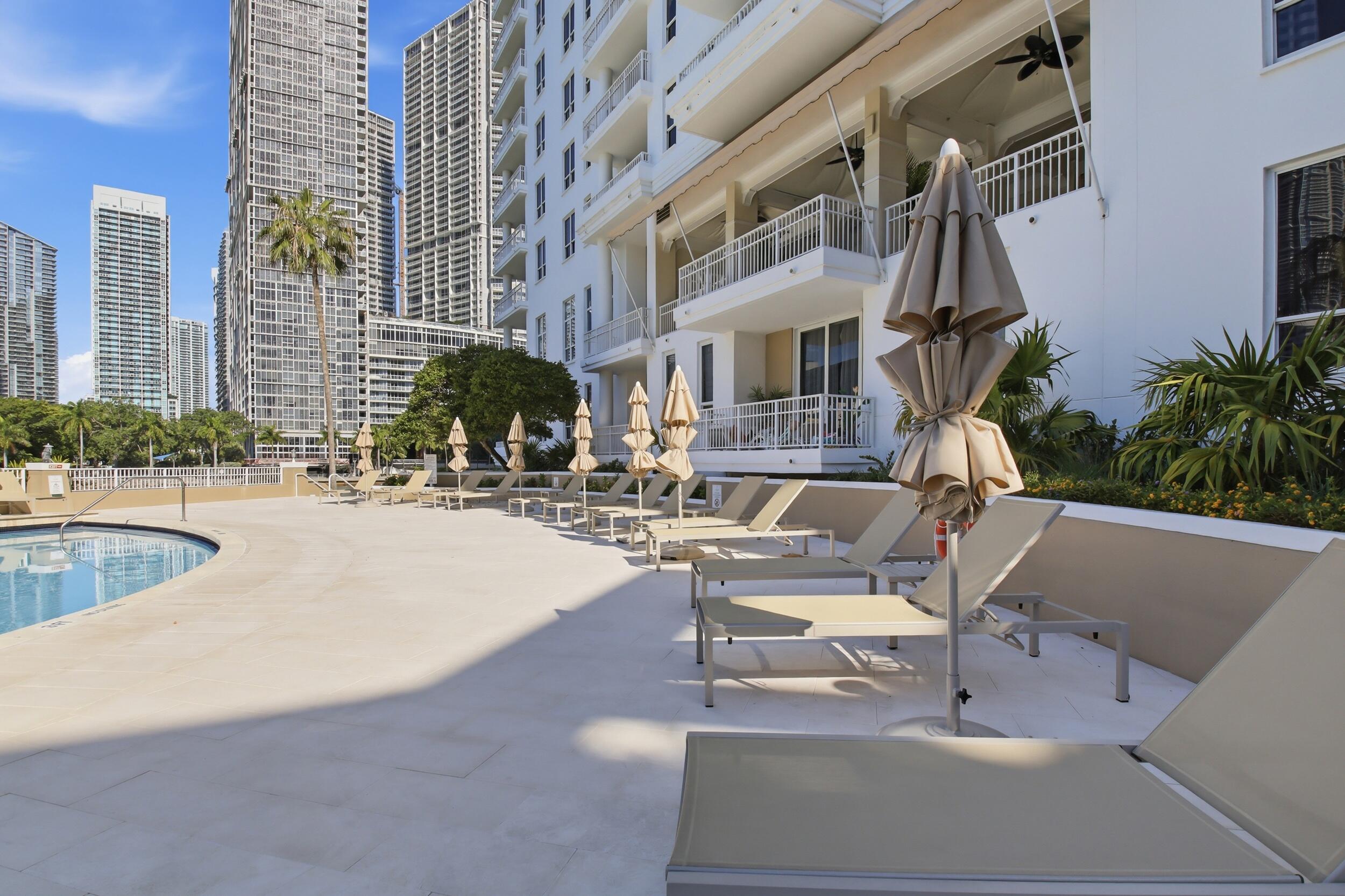 701 Brickell Key Boulevard, Unit 610 Miami, FL 33131 - Photo 4 of 40 a swimming pool with outdoor seating and yard