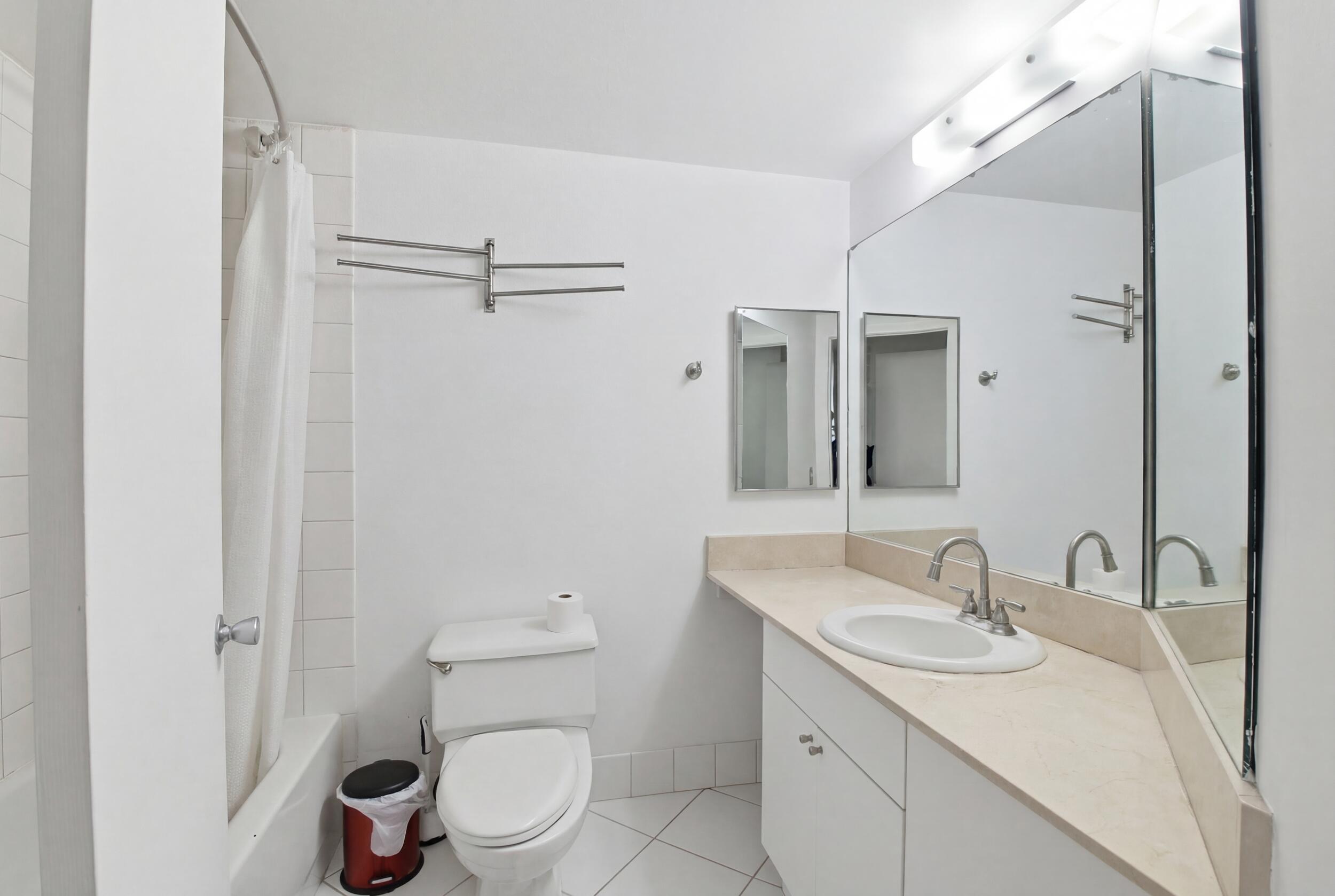 701 Brickell Key Boulevard, Unit 610 Miami, FL 33131 - Photo 7 of 40 a bathroom with a granite countertop sink toilet and shower