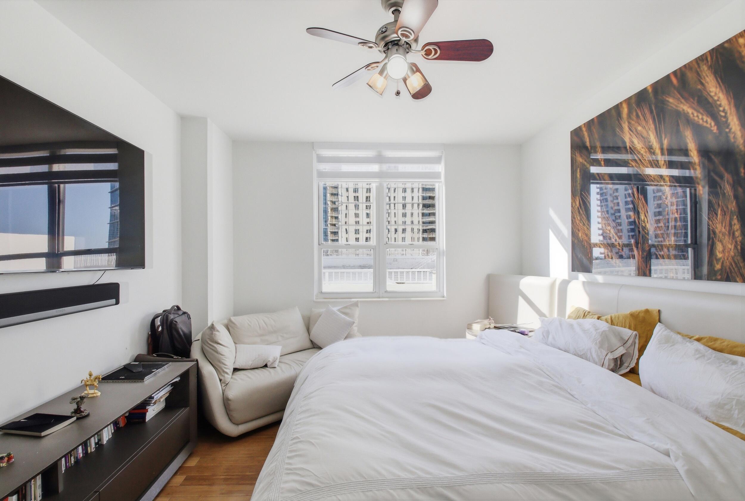 701 Brickell Key Boulevard, Unit 610 Miami, FL 33131 - Photo 8 of 40 a bedroom with a bed couch and window