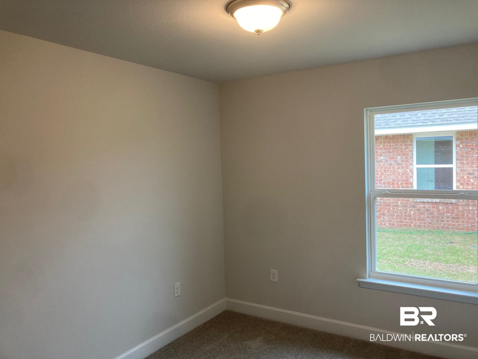 649 Revere Street Foley, AL 36535 - Photo 8 of 18 Spare room featuring carpet and baseboards