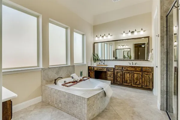 a bathroom with a tub sink and mirror