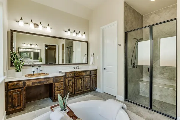 a en suite bathroom with a double vanity sink mirror and shower