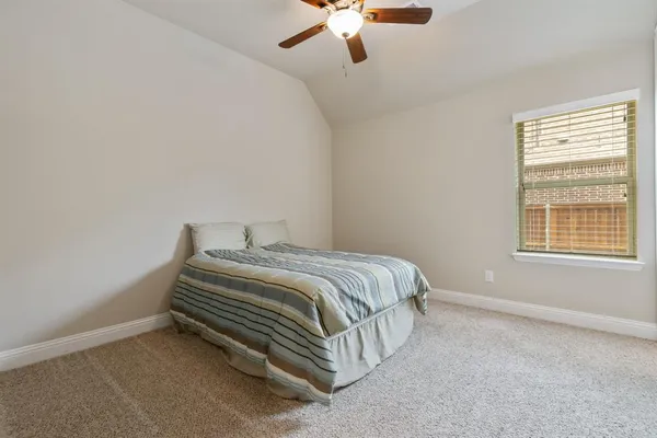 a bedroom with a bed and window