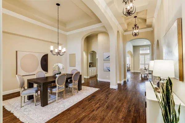 a view of a dining room with furniture wooden floor and chandelier
