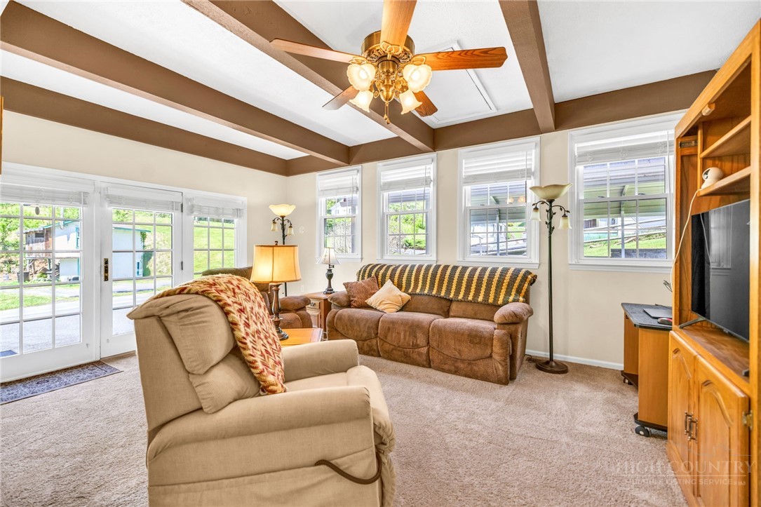 346 Piney Creek Road Lansing, NC 28643 - Photo 13 of 24 a living room with furniture a flat screen tv and a large window