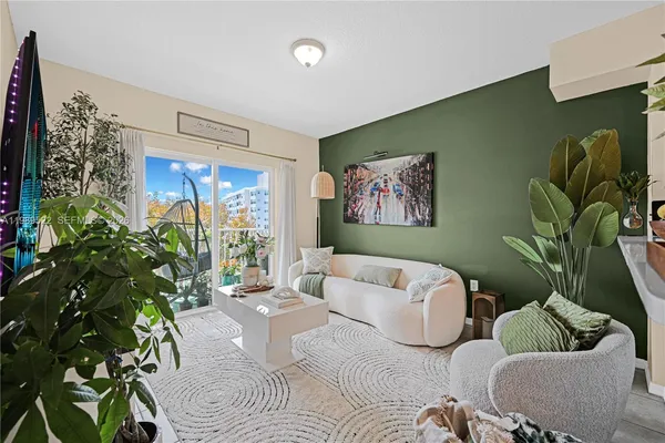 a living room with furniture and a potted plant