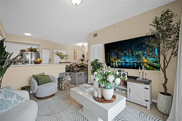 a living room with furniture and a potted plant