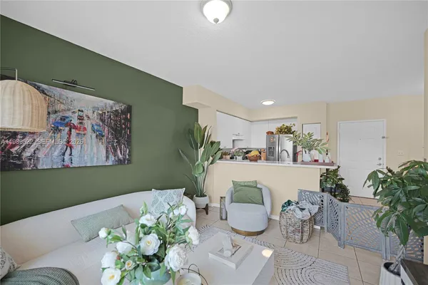 a living room with furniture and a potted plant