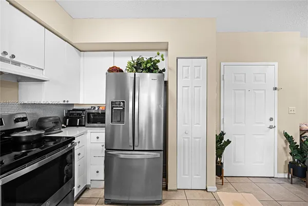 a kitchen with stainless steel appliances a refrigerator and a stove top oven