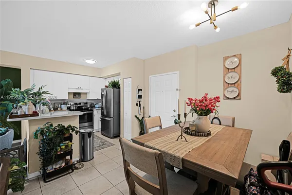 a view of a dining room with furniture and kitchen view