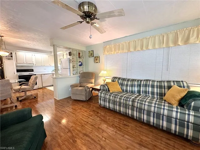 a living room with furniture or couch and a chandelier