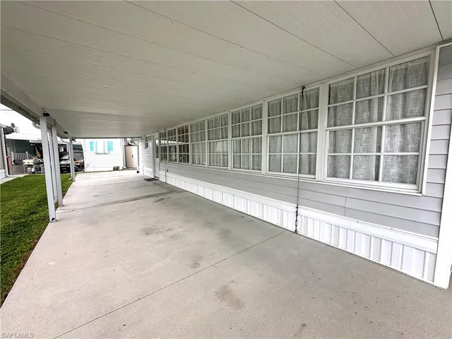 a view of a house with a wooden fence