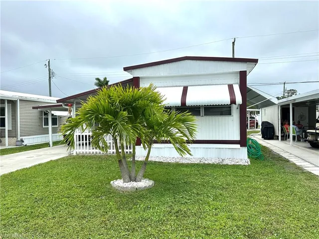 a balcony with table and chairs and wooden floor