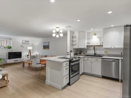a kitchen with granite countertop a sink and white cabinets