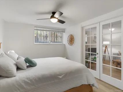 a bedroom with a bed and a chandelier