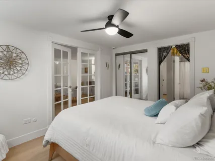 a bedroom with a large bed and a chandelier