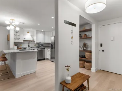 a kitchen with stainless steel appliances kitchen island granite countertop a refrigerator and a stove top oven