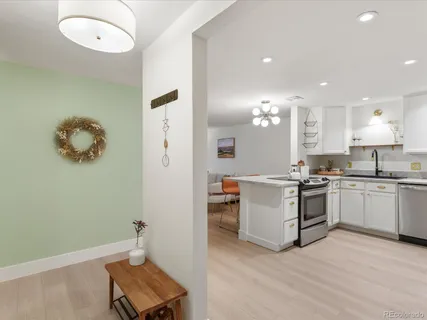 a kitchen with a refrigerator and a stove
