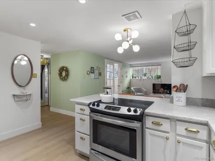 a stove top oven sitting inside of a kitchen