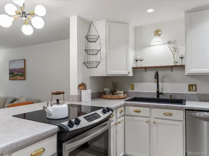 a kitchen with a sink cabinets and stove