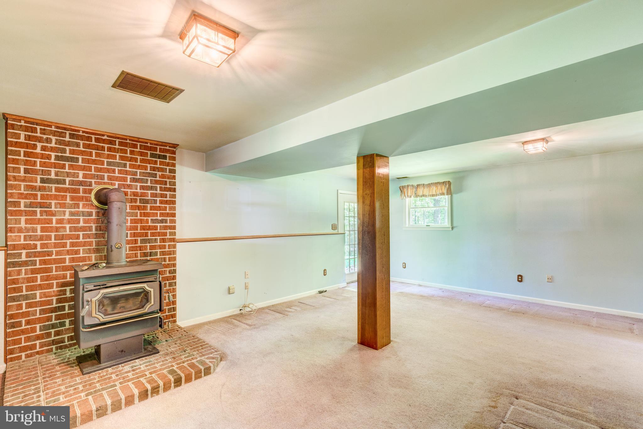 2409 Stone Road Westminster, MD 21158 - Photo 17 of 36 Finished Lower Level #1 w/woodstove