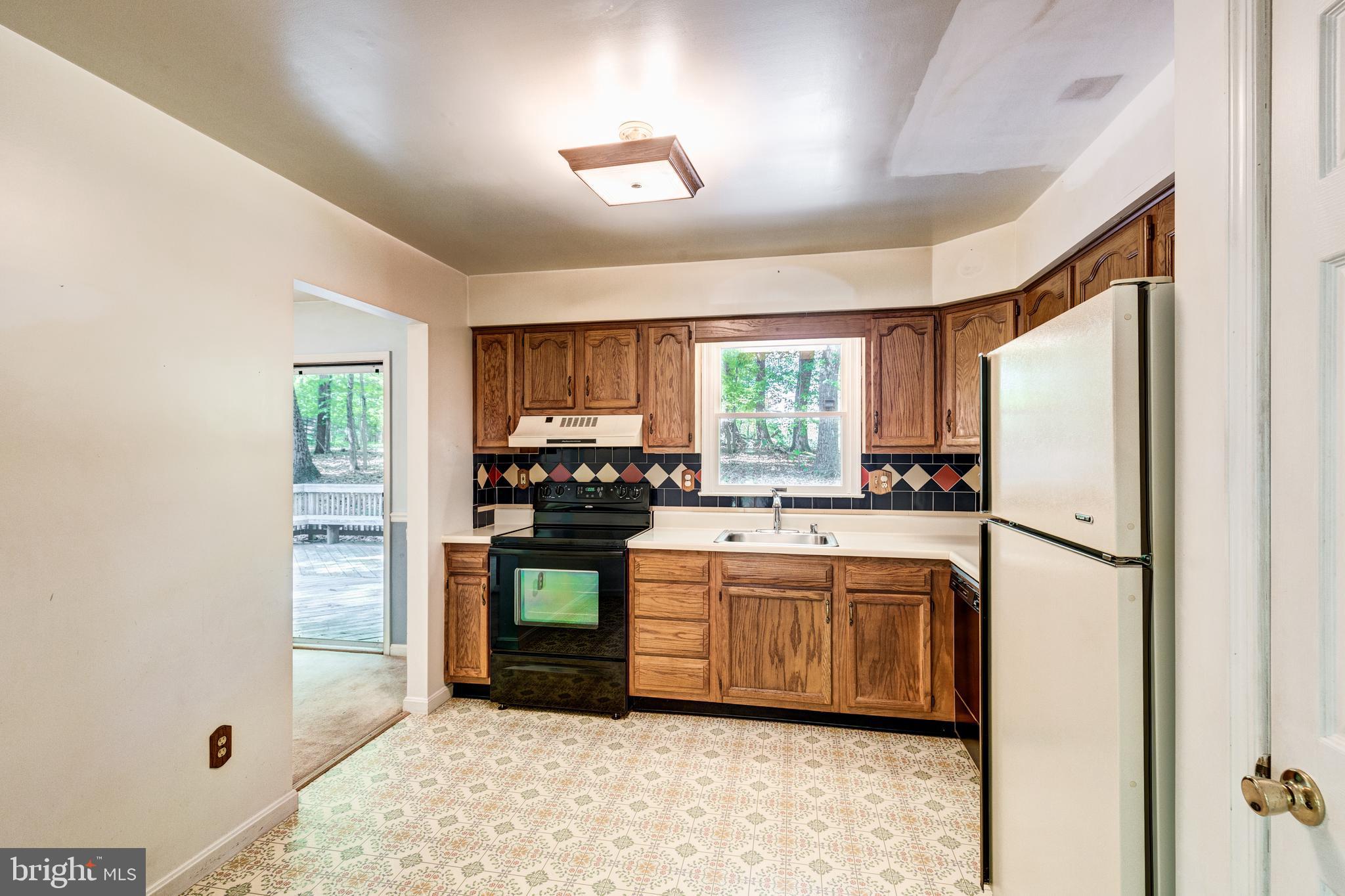 2409 Stone Road Westminster, MD 21158 - Photo 10 of 36 Kitchen window overlooks deck & trees beyond