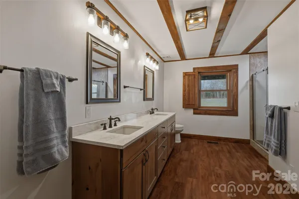 a bathroom with a glass shower door