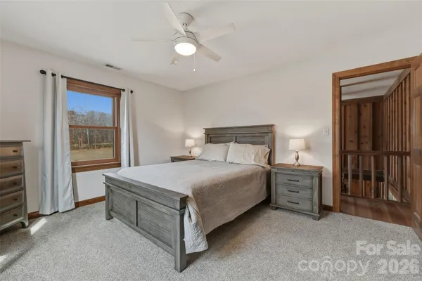 a bathroom with a double vanity sink mirror and next to a window