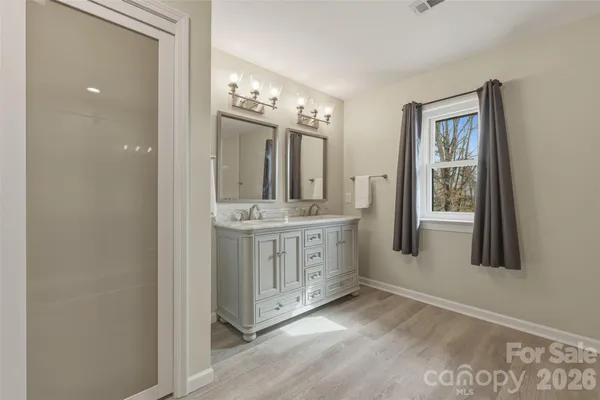 a spacious bedroom with a bed and a chair