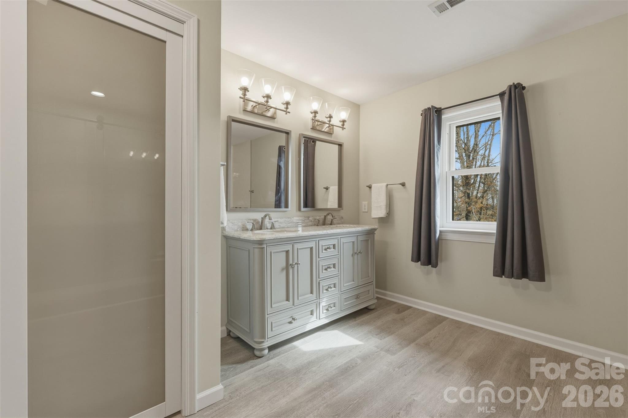 2255 Mt Olive Church Road Newton, NC 28658 - Photo 20 of 43 a bathroom with a double vanity sink mirror and next to a window